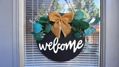 a welcome sign hanging on a window with a door at Gorgeous Guest Suite - Walk to Old Town and CSU! in Fort Collins