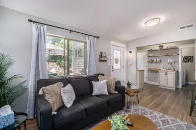 a living room with a couch and a table at Gorgeous Guest Suite - Walk to Old Town and CSU! in Fort Collins
