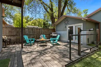 a patio with chairs and a table and a grill at Industrial Old Town Bungalow with Free Cruiser Bikes in Fort Collins
