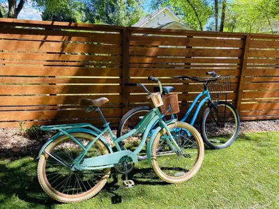 two bikes are parked next to a fence at Industrial Old Town Bungalow with Free Cruiser Bikes in Fort Collins