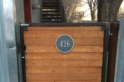 a wooden garage door with a sign on it at Industrial Old Town Bungalow with Free Cruiser Bikes in Fort Collins