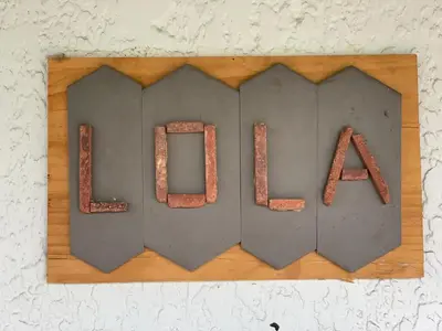 a metal sign that says load on a cutting board at Lola House! Cozy Comfort, Prime Old Town Location in Fort Collins