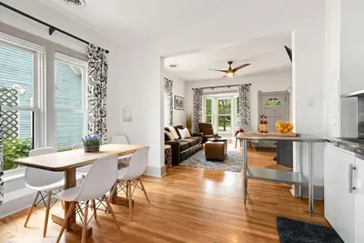 a kitchen and living room with a table and chairs at Lola House! Cozy Comfort, Prime Old Town Location in Fort Collins