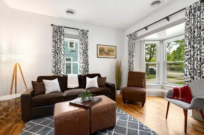 a living room with a couch and a chair at Lola House! Cozy Comfort, Prime Old Town Location in Fort Collins