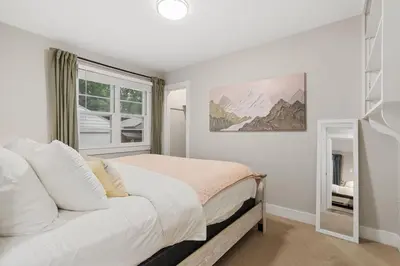 a white bedroom with a bed and a window at Beautiful Bungalow Next to CSU, Free Cruiser Bikes in Fort Collins