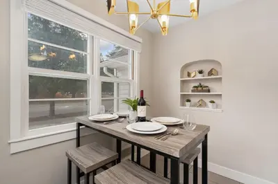 a dining room with a table and a window at Beautiful Bungalow Next to CSU, Free Cruiser Bikes in Fort Collins