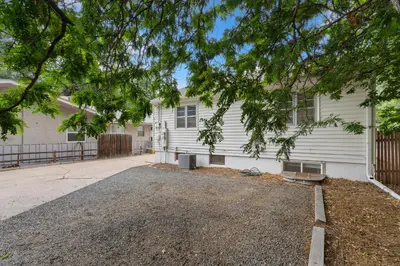 a house with a driveway in front of it at Beautiful Bungalow Next to CSU, Free Cruiser Bikes in Fort Collins