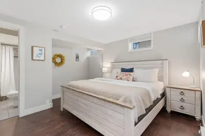 a bedroom with a large bed and a bathroom at Charming Bungalow Next to CSU - Free Cruiser Bikes in Fort Collins