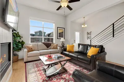 a living room with a couch and a fireplace at Modern Townhome Steps from the Brewery District! in Fort Collins