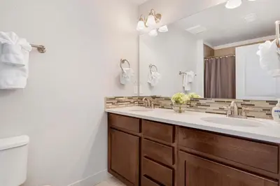 a bathroom with a sink and a mirror at Modern Townhome Steps from the Brewery District! in Fort Collins