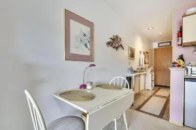 a kitchen with a white table and chairs in a room at Cedar Lodge 221 condo in Frisco
