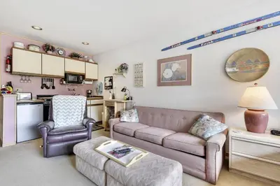 a living room with a couch and a chair at Cedar Lodge 221 condo in Frisco