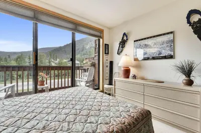 a bedroom with a bed and a large window at Cedar Lodge 221 condo in Frisco