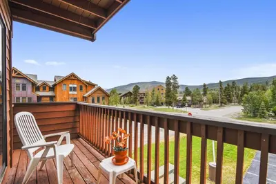 a balcony with two chairs and a view of a street at Cedar Lodge 221 condo in Frisco
