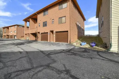 a building with two garage doors on the side of it at Lagoon 736D townhouse in Frisco