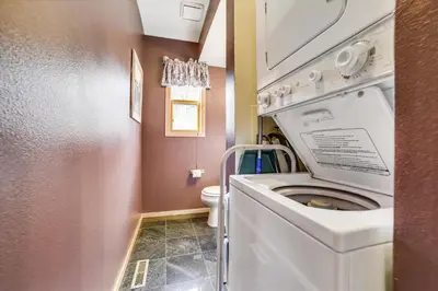 a small bathroom with a washer and dryer at Lagoon 736D townhouse in Frisco