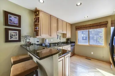 a kitchen with wooden cabinets and a counter top at Lagoon 736D townhouse in Frisco