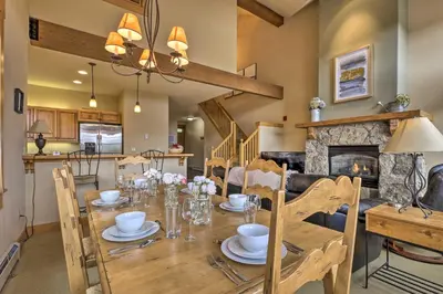 a dining room with a table and a fireplace at 3 Mi to Keystone Resort Condo with Mountain View in Keystone