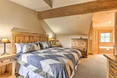 a bedroom with a large bed with a wooden headboard at 3 Mi to Keystone Resort Condo with Mountain View in Keystone