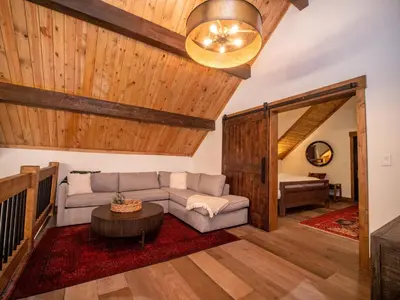 a living room with a couch and a table at Rocky Mountain Escape - Steps to Lake Estes, Jacuzzi, Close to Downtown Estes in Estes Park