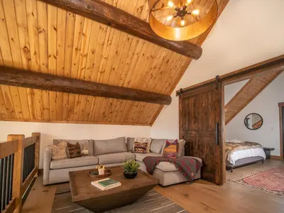 a living room with a couch and a table at Estes Escape – Jacuzzi, Indoor/Outdoor Fireplace and BBQ Grill in Estes Park