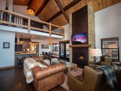 a living room with a couch and a fireplace at Lake Estes Getaway – Close to Downtown, Indoor/Outdoor Fireplace and Jacuzzi in Estes Park