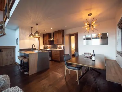 a kitchen with a table and a dining room at Lake Estes Getaway – Close to Downtown, Indoor/Outdoor Fireplace and Jacuzzi in Estes Park