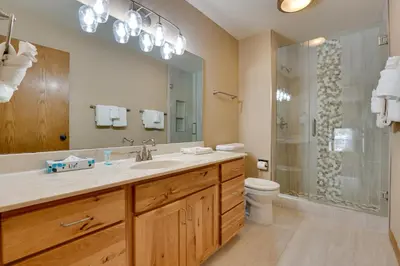 a bathroom with a sink and a toilet and a mirror at Deck and Mtn View Keystone Townhome Near Resort! in Keystone