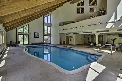 a large indoor swimming pool with a wooden ceiling at Deck and Mtn View Keystone Townhome Near Resort! in Keystone