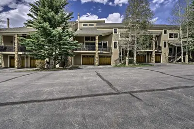 an empty parking lot in front of a large house at Deck and Mtn View Keystone Townhome Near Resort! in Keystone