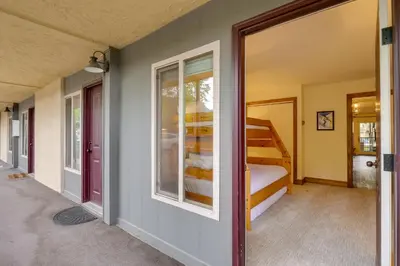 a room with a bed and a sliding glass door at Walk to Ski Shuttle Cozy Mountain Meadows Condo in Frisco