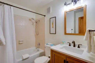 a bathroom with a sink and a toilet and a mirror at Walk to Ski Shuttle Cozy Mountain Meadows Condo in Frisco