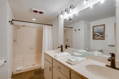 a bathroom with a sink and a large mirror at Walk to Ski Shuttle Cozy Mountain Meadows Condo in Frisco