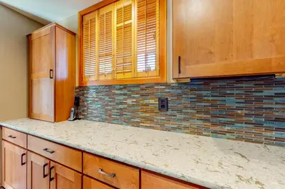 a kitchen with wooden cabinets and a tile back splash at Red Fox in Dillon
