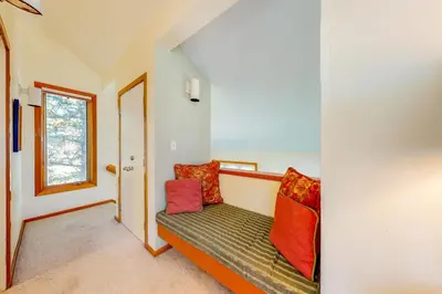 a room with a bench with colorful pillows at Red Fox in Dillon