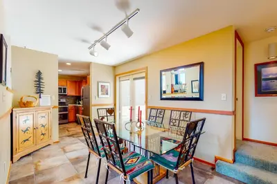 a dining room with a glass table and chairs at Red Fox in Dillon