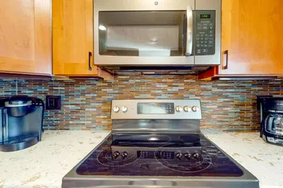 a kitchen with a stove and a microwave at Red Fox in Dillon