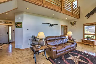a living room with a leather couch and a table at 2 Mi to Granby Ranch Granby Home with Hot Tub! in Granby