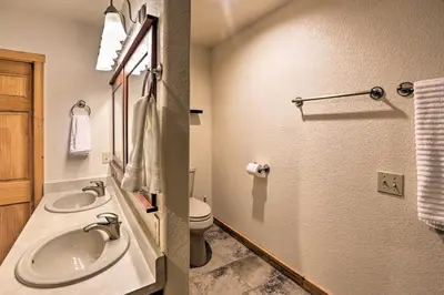 a bathroom with a sink and a toilet at 2 Mi to Granby Ranch Granby Home with Hot Tub! in Granby