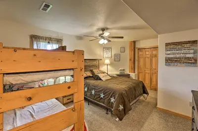 a bedroom with a bed and a ceiling fan at 2 Mi to Granby Ranch Granby Home with Hot Tub! in Granby