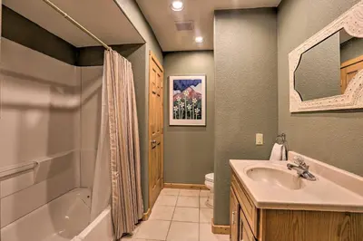 a bathroom with a tub and a sink and a shower at 2 Mi to Granby Ranch Granby Home with Hot Tub! in Granby
