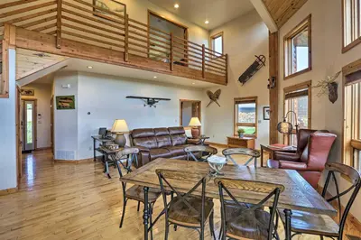 a living room with a table and chairs at 2 Mi to Granby Ranch Granby Home with Hot Tub! in Granby