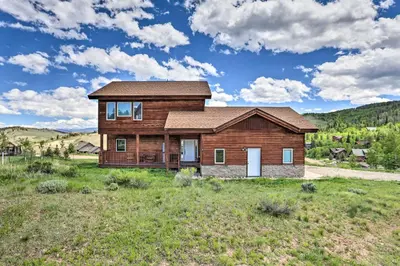 a log home in the middle of a field at 2 Mi to Granby Ranch Granby Home with Hot Tub! in Granby