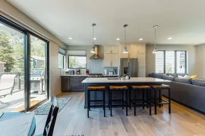 an open kitchen and living room with a table and chairs at Woodhaven Hideaway in Frisco