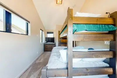 a bedroom with two bunk beds in a house at Woodhaven Hideaway in Frisco