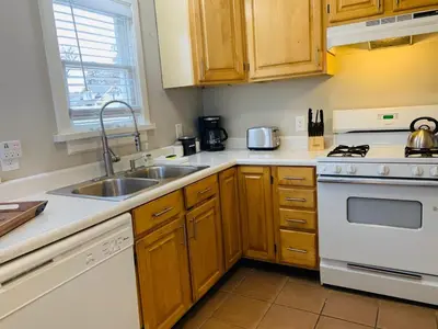 a kitchen with a sink and a stove at Stunning Bungalow next to UNC - Free Bikes! in Greeley