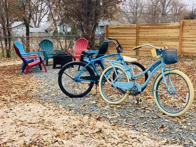 a blue bike parked in front of colorful chairs at Stunning Bungalow next to UNC - Free Bikes! in Greeley