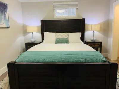 a bedroom with a large bed with two lamps at Inviting Bungalow Next to UNC - Free Cruiser Bikes in Greeley