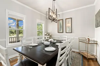 a dining room with a black table and white chairs at Fabulous Family-Friendly Retreat by Windsor Lake! in Windsor