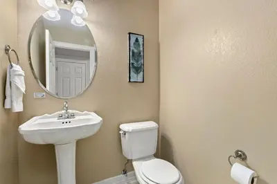a bathroom with a sink and a toilet and a mirror at Fabulous Family-Friendly Retreat by Windsor Lake! in Windsor